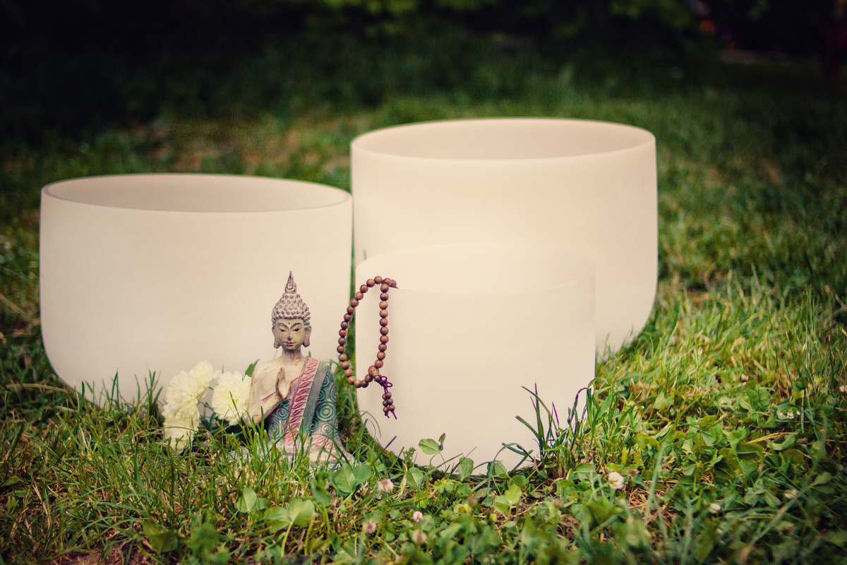 Crystal singing bowls. Meditation and Budha in the park.