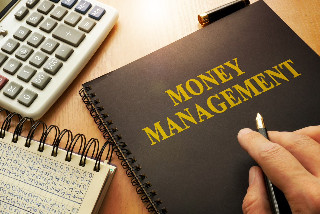 Book with money management on a table.